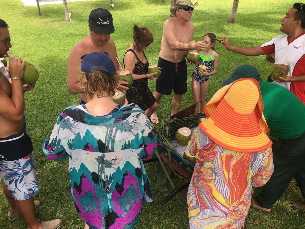 Guests enjoying fresh coconuts at Riu Palace Mexico