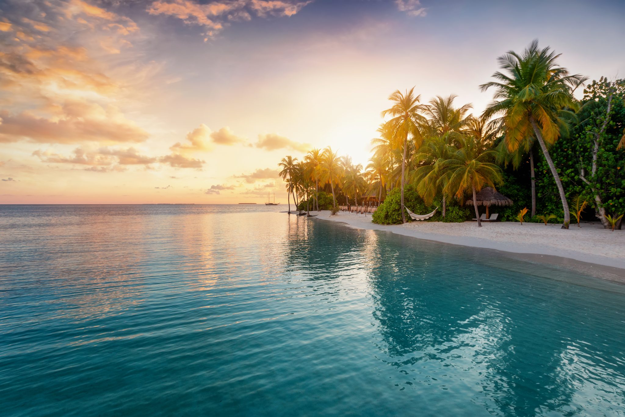 Sunrise behind a tropical island in the Maldives Blog