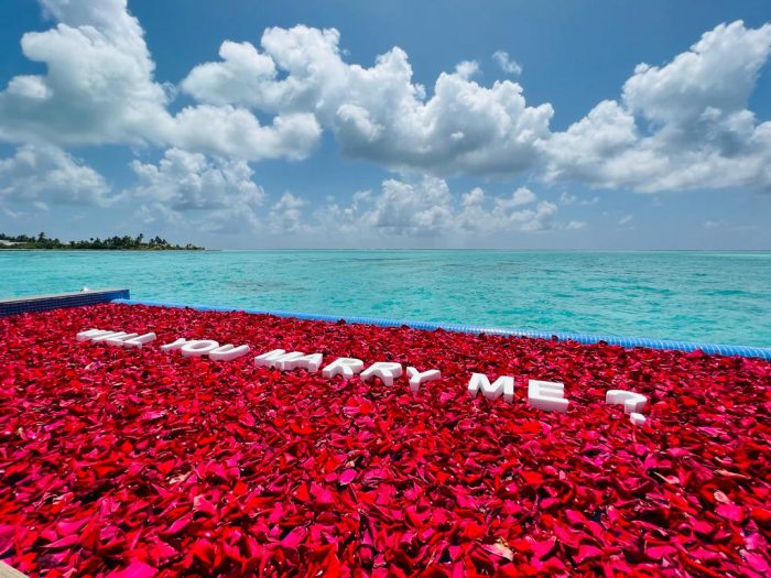 A marriage proposal in the pool of an overwater room at Hotel Riu Palace Maldivas.