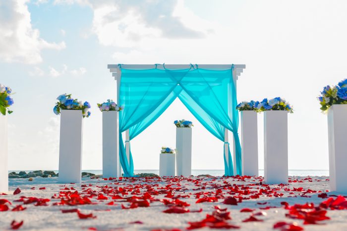Ein mit Blütenblättern und Blumen geschmückter Traualtar für eine Hochzeitszeremonie mit RIU auf den Malediven