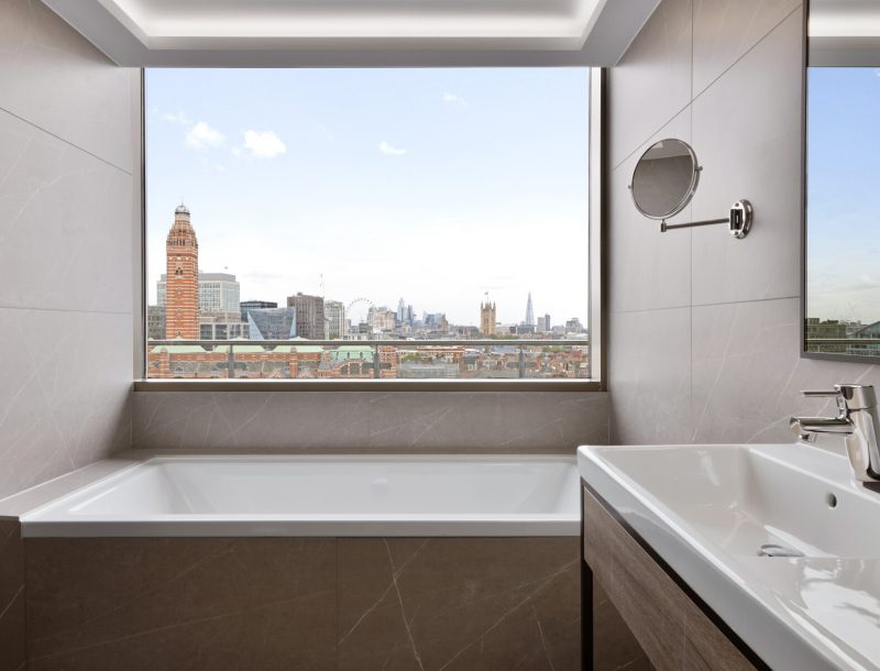 The bathroom in the Presidential Suite at the hotel Riu Plaza London Victoria with a view of Victoria Station and other London landmarks