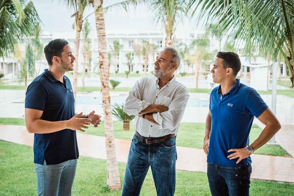 Roberto Riu and Luis Riu Rodríguez with their father, Luis Riu Güell, outside the Hotel Riu Montego Bay in Jamaica