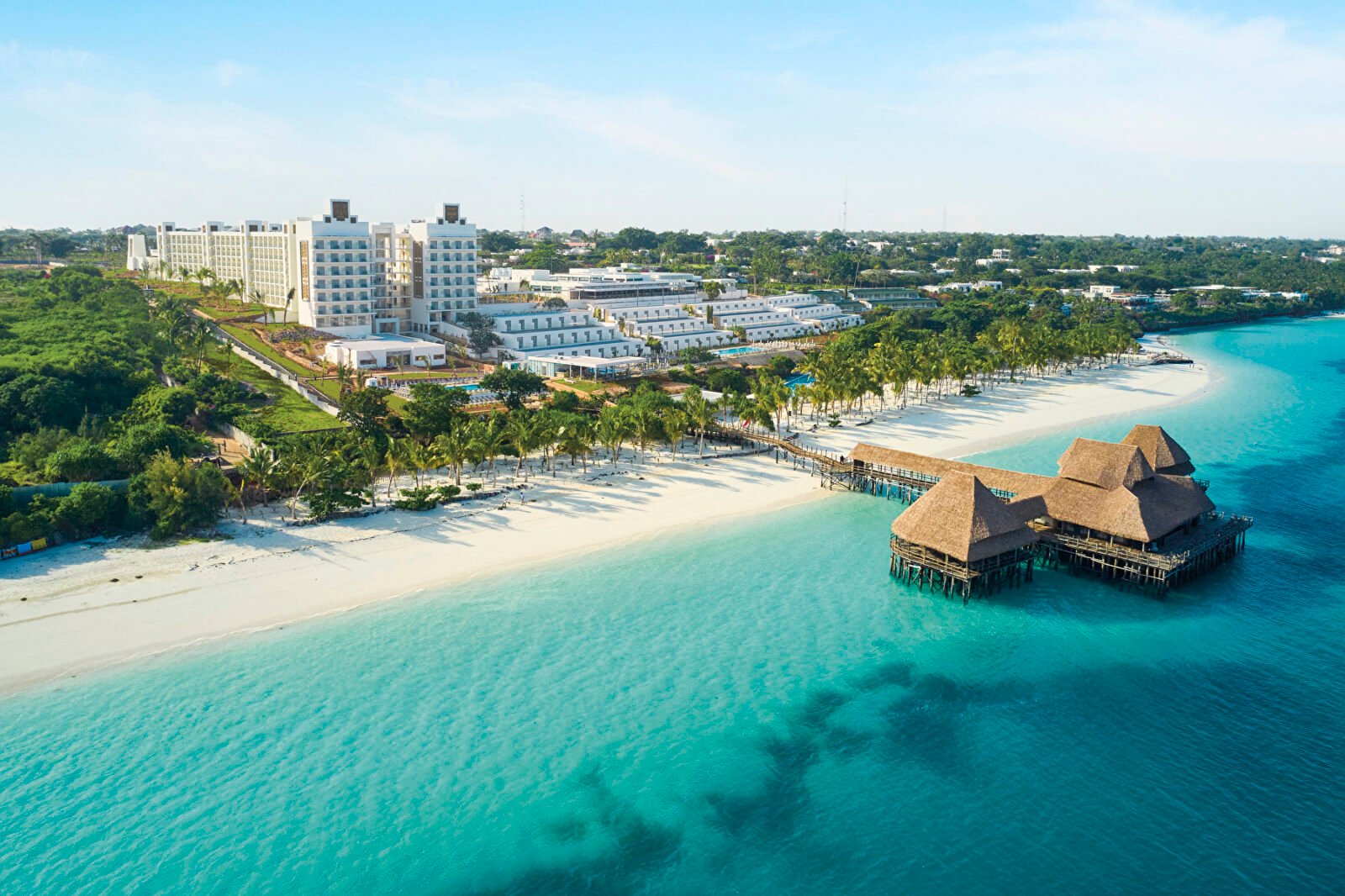  Aerial view of the Hotel Riu Jambo in Zanzibar, featuring a traditional jetty over the sea and the Nungwi beach