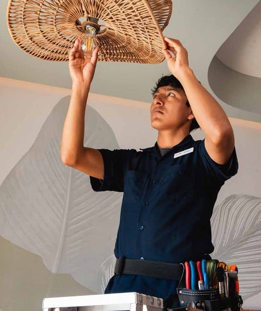 A RIU worker changes a light